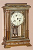 French, Marti et Cie, Circa 1900, 8-day time and gong strike brass and enamel crystal regulator mantel clock, w/ original 2-vial compensating pendulum; multi color enamel trim on case top, bottom and bezel, and with matching polychrome wreaths on the dial.