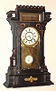 F. Kroeber Clock Co., New York, LEHIGH, ebonized mantel clock with gold accents, and with fancy indicator pendulum and gilt tablet, 8-day gong strike, c.1879