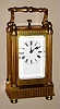 Swiss, carriage clock, miniature quarter hour repeater movement in Empire style polshed brass case with Roman numeral porcelain dial, c1900