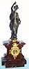 French bronze figural mantel clock with conical pendulum 8 day time and strike spring driven movement in rouge marble case surmounted by a bronze Classical female figure signed "Laurent" holding a polished silvered turned pendulum rod surrounded by a gilt tube and with a star studded blue spherical bob, the dial with applied Roman numeral gilt chapter ring and exposed skeletonized movement, c1870