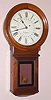 E. Howard and Co., Boston, "No. 70, PROGRAM CONTACT CLOCK", based on the No. 70 regulator and with and iron back behind the circular, laminated head, the dial insulated from the iron back on 4 wooden blocks, and with 2 bronze rings with holes at 5 minute intervals, the rings wired to an electrical stud in top of clock and the iron back/movement wired to the other stud. Walnut case. C.1910