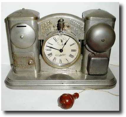 C.1910, Darche Mfg. Co., "Flashlight Electric Alarm Bank shelf clock and Call clock". — Antique Clocks Price Guide