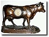 C.1930, Novelty of a bronzed iron cow figure advertising shelf clock
