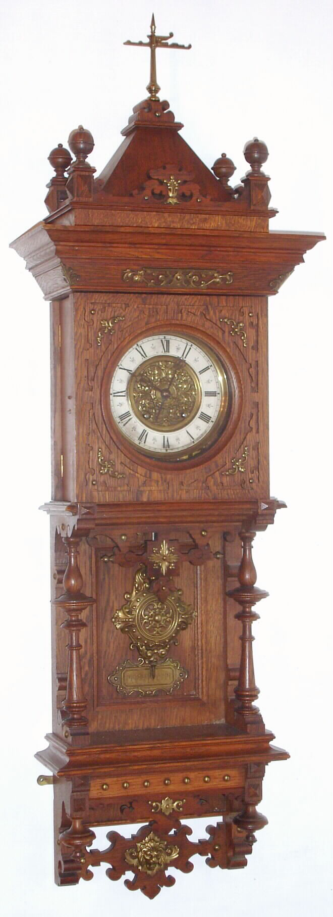 German, Lenzkirch, oak cased wall clock, the lower case with full turned columns and open-well construction showing the pendulum in full view, and the case with profuse bronze trimmings, c.1880, serial 723874 — Antique Clocks Price Guide