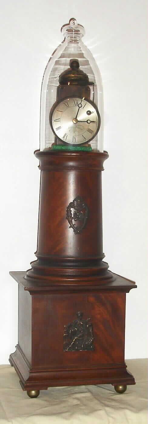 Reproduction Simon Willard lighthouse clock, C. 1960, weight driven, 8-day, passing strike, in a square based mantel case with glass bell jar over movement. — Antique Clocks Price Guide