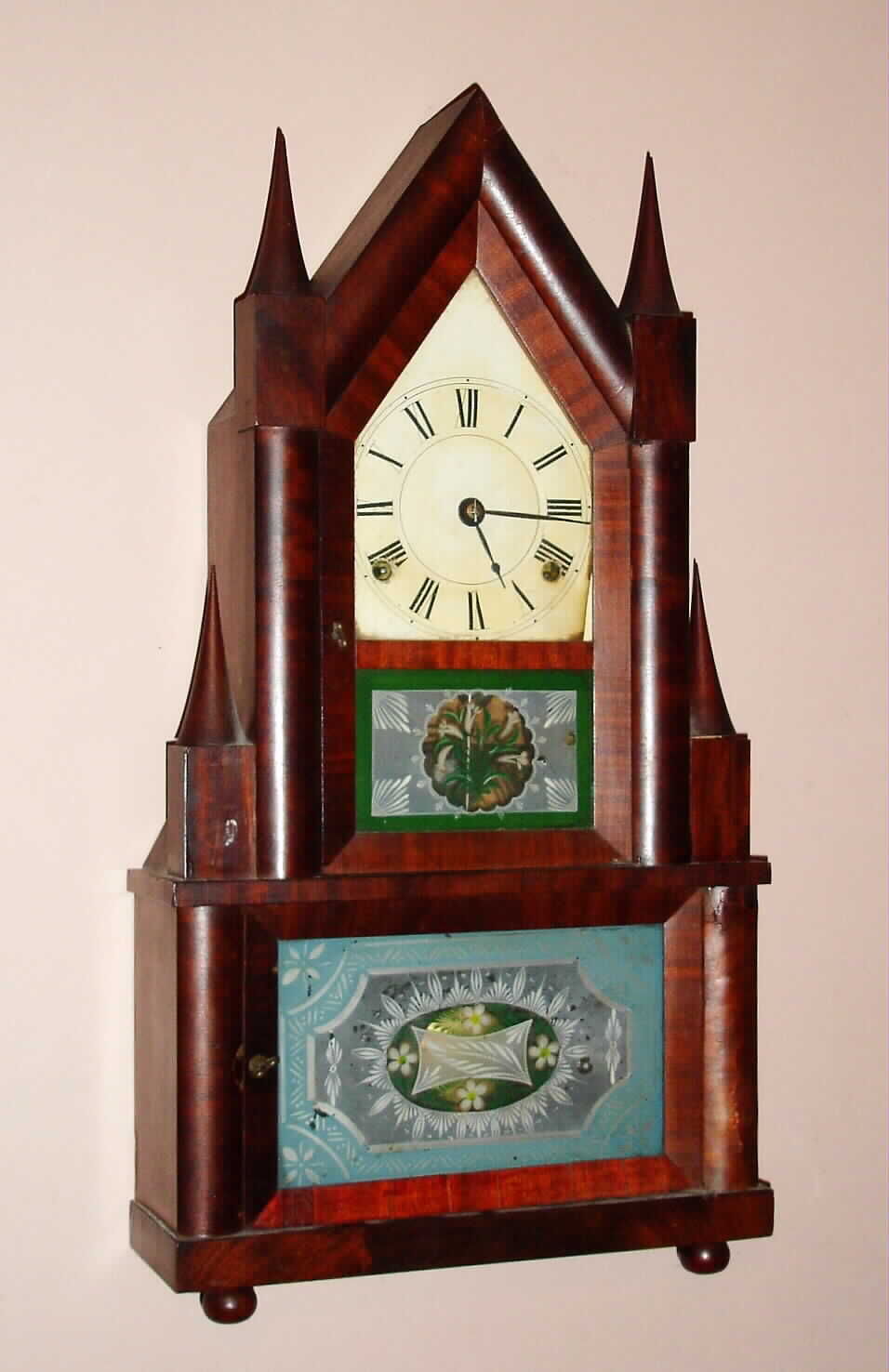 Elisha Manross, Bristol, Conn, double steeple 8 day time and strike spring driven double fusee mvt in mahogany veneered case on ball feet with reverse painted tablets, c1845. Note heavy strap brass movement with heavy cast iron bracket for spring barrels. — Antique Clocks Price Guide