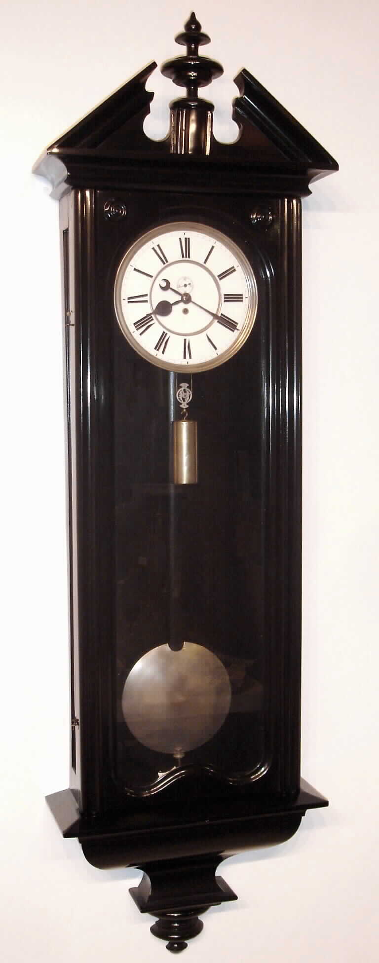 F. Kroeber Clock Co., New York, "Regulator No. 19", a large ebonized 'Vienna' style regulator, with 10 inch dial and longer 66 beat pendulum, the porcelain dial with spade hands and seconds bit, and with nickel plated bezel, bob and pulley, from the Kent Kroeber collection, log #26, c.1885. — Antique Clocks Price Guide