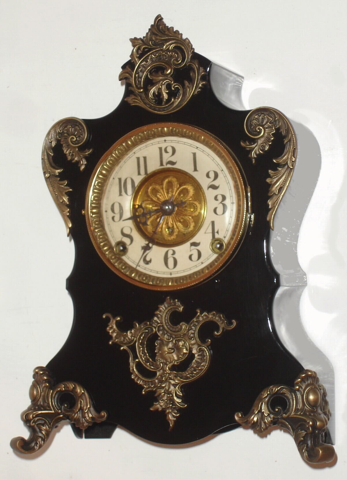 F. Kroeber Clock Co., New York "Voltaire" mantel clock 8 day time and strike spring driven Eclipse movement in enameled black iron case with cast metal appliquEs, c1895 — Antique Clocks Price Guide
