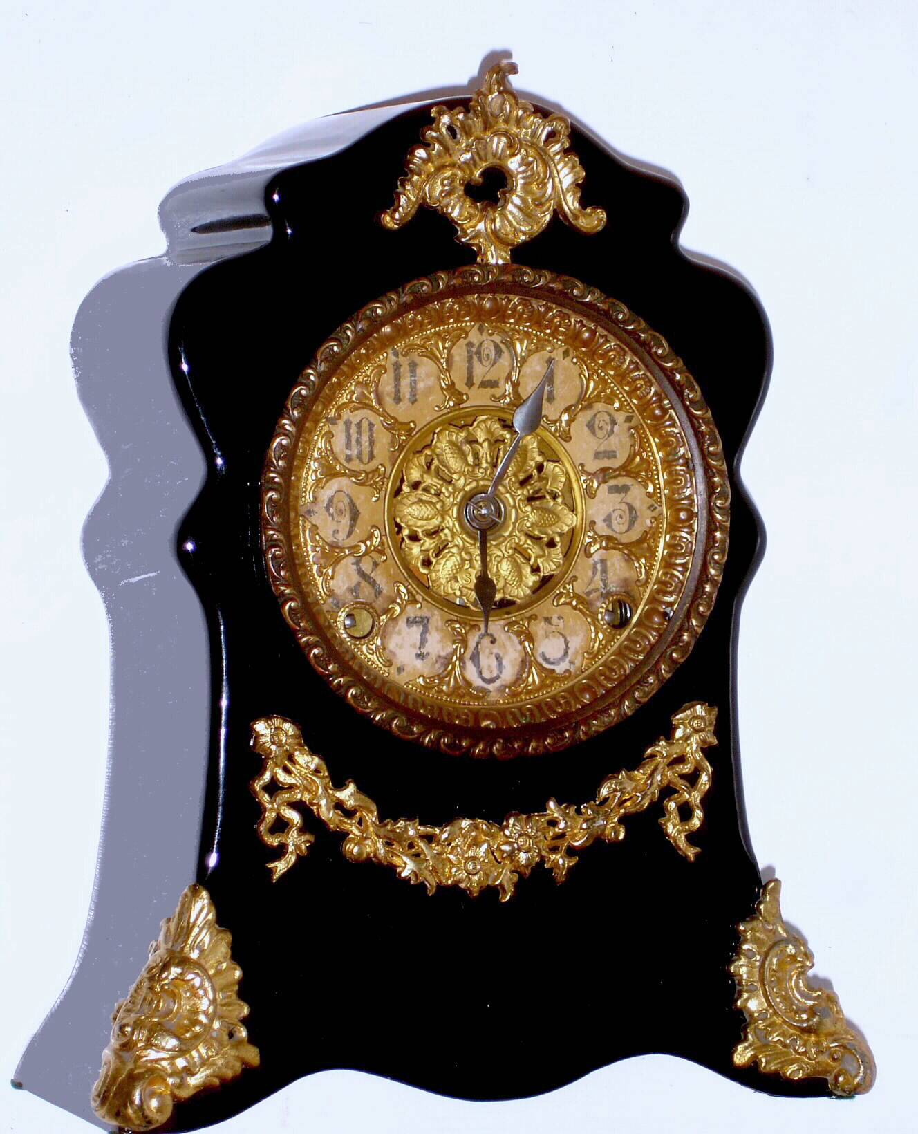 F. Kroeber Clock Co., New York "Toulon" 8 day time and strike spring driven Clubs movement in black enameled iron case with cast metal appliques, c1895 — Antique Clocks Price Guide