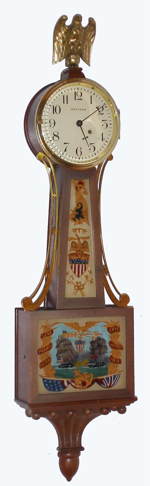 Waltham Clock Co., Waltham, Mass., "No. 1550" miniature banjo wall clock 8 day time only key wind spring driven movement in mahogany flat front case with reverse painted throat and lower tablets, c1930 — Antique Clocks Price Guide