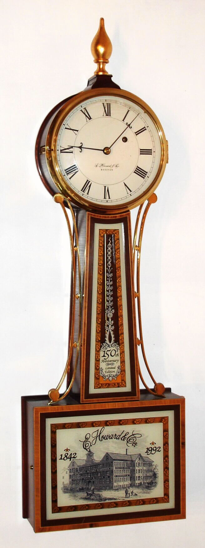 E. Howard Clock Co., Boston, 150th Anniversary limited edition banjo wall clock with 8 day time only weight driven damascened movement in mahogany case. A small brass plaque mounted in lower case gives the name of the original owner and is marked and "SN 8", both case and movement stamped "263", c1992 — Antique Clocks Price Guide