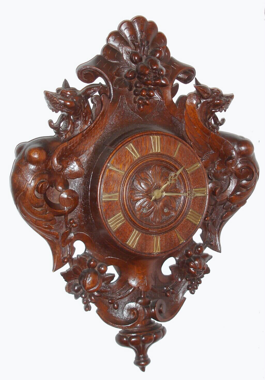 French or Swiss carved wall clock 8 day time and gong strike spring driven French movement in a large finely carved case with floral and fruit motif flanked by two winged dragon creatures, c1880 — Antique Clocks Price Guide