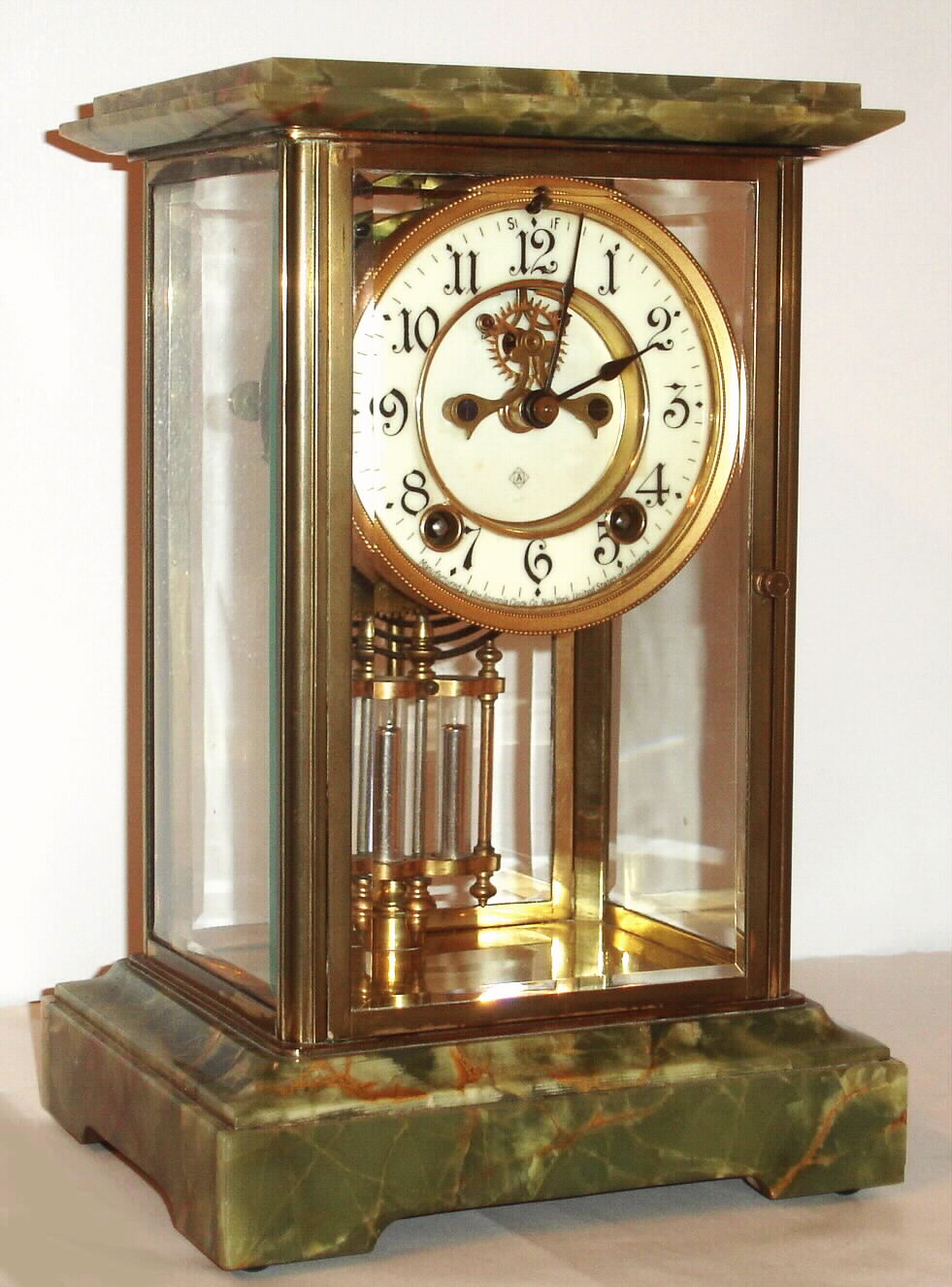 Ansonia Clock Co., "Ambassador", 8-day time/strike brass and onyx crystal regulator, with open 'scape on dial center, C. 1914 — Antique Clocks Price Guide