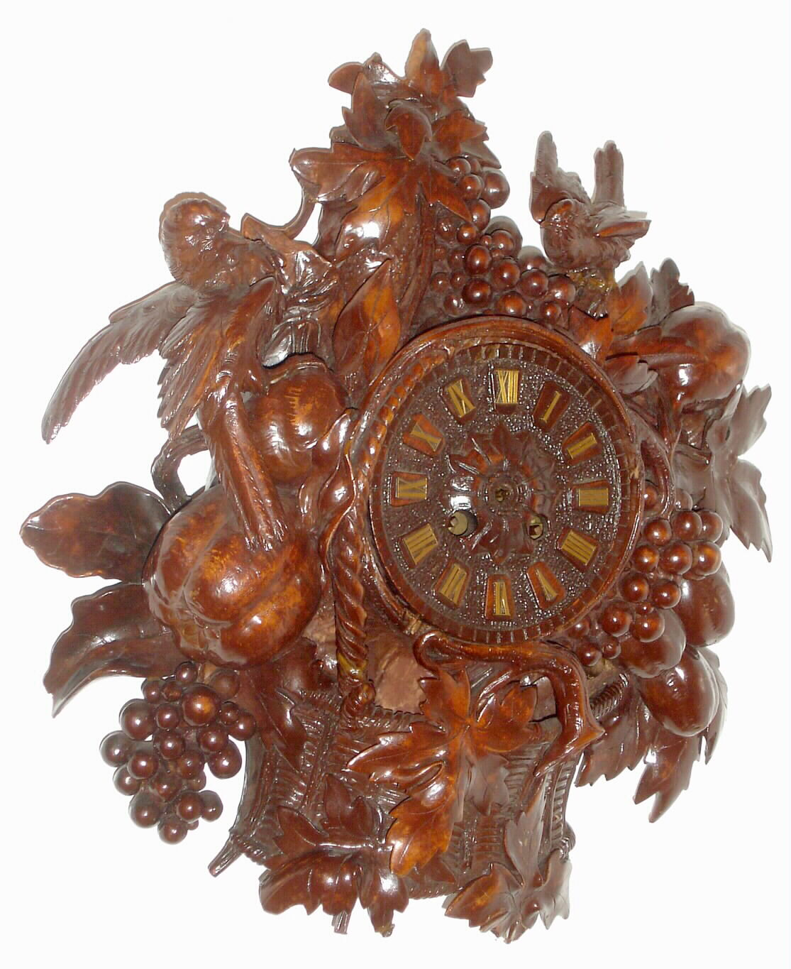 Swiss, probably Interlaken area, Black Forest style carved wooden cartel clock, with grapes, pomegranate and plums amid leaves and with birds at top, fitted with a French, Vincenti 8-day time and bell strike movement. — Antique Clocks Price Guide