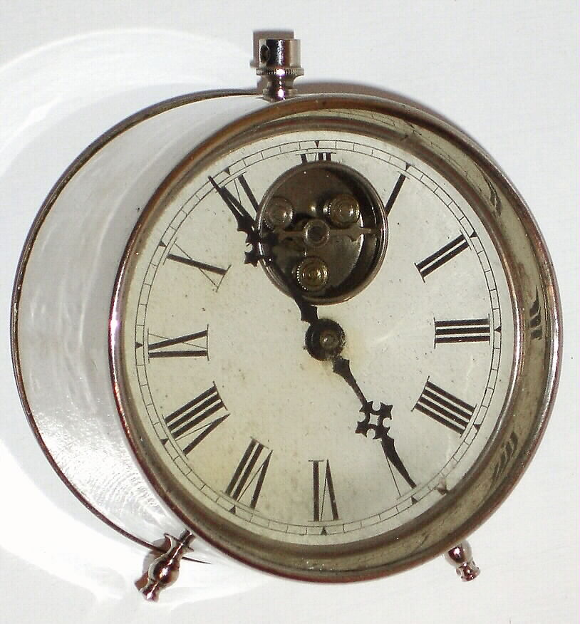 Terry Clock Co, "Tin Can Clock" C. 1888, 30-hour travel timepiece, with exposed 3-lobe balance on the dial — Antique Clocks Price Guide
