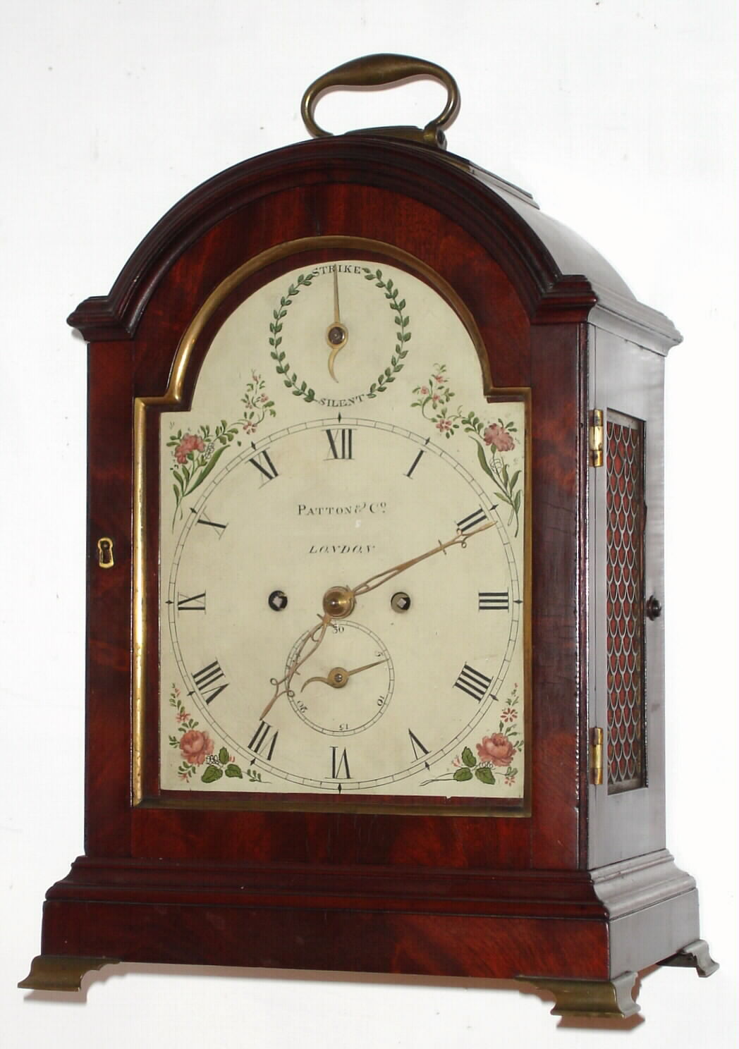 English, Patton and Co., London, 8-day time and bell strike, twin fusee movement, mahogany case bracket clock, with strike-silent dial in the arch, and with fan style brass side frets and brass bracket feet, C. 1810 — Antique Clocks Price Guide