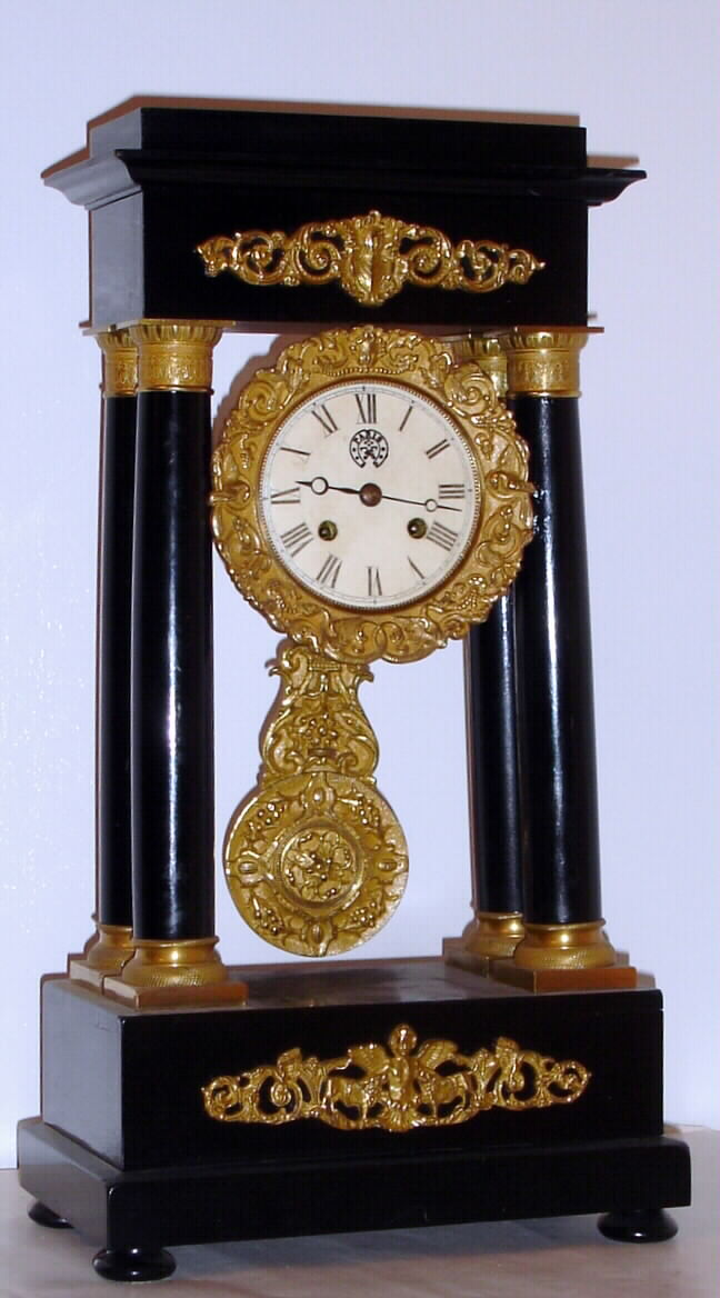 French, 8-day time/strike, Empire style portico 4-column in an ebonized case with gilt bronze mounts, gilt dial and pendulum mantel clock, C. 1860 — Antique Clocks Price Guide