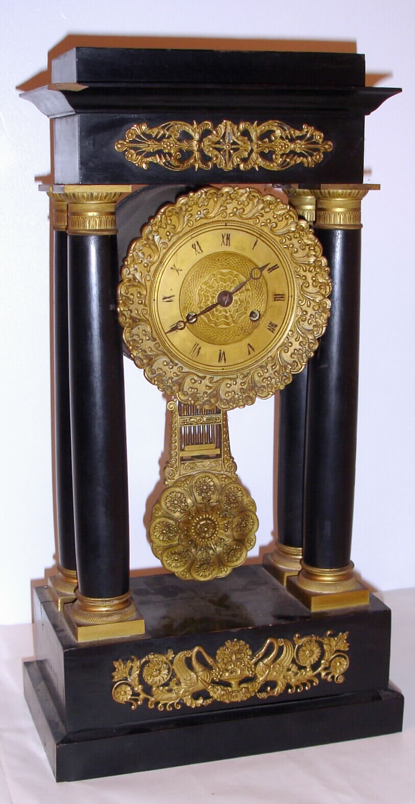 French, 8-day time/strike 4-column Empire style mantel clock in an ebonized case with gilt bronze mounts and pendulum, C. 1860 — Antique Clocks Price Guide