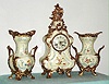 German, Lenzkirch, 3-piece mantel set of porcelain with ormolu adornments, and with quality round movement with porcelain dial and fancy brass hands, the case and side pieces with floral trim, c.1875.