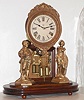 Ansonia Clock Co, "Crystal Palace", showing a hunter and net fisher, and with heavy cast bezel and barrel pendulum, the whole covered by a replacement glass dome, c1880