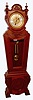 Waterbury Clock Co, rare floor standing Regulator No. 62, in a mahogany case with unusual keystone shape, quality 2-weight striking mov't and silvered dial with raised brass numerals and fancy center.