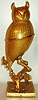 Music box Swiss, playing 2 tunes - Fledermaus and Skater's Waltz set within gilt owl figure with jewel set eyes, perched on limb, c1925