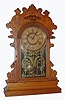 Wm.L. Gilbert Clock Co., Winsted Conn., oak gingerbread 8-day time and strike kitchen clock, C.1895.