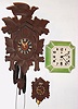 Clocks- (3) wall clocks: a cuckoo with bone hands, a Lux Clock Mfg Co. miniature cuckoo and a Celebrate 8 day porcelain spring driven clock