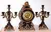 F. Kroeber Clock Co., New York, "Louis XIV" three piece garniture set with 8 day time and strike spring driven movement in black enamel cast iron case with polished brass appliquEs and matching black enamel and brass cast iron candelabra, c1895