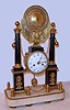 Roque, Paris, French architectural mantel clock with 8 day time and strike on bell spring driven movement engraved with the maker's name and No. 1282. The clock rests on white marble base supporting six posts linked by chain with two marble pillars with ormolu appliques and finials centered by brass spread wing eagle perched above movement supporting ornately floral embossed medallion. The porcelain dial has intricately pierced brass hands and is signed Roque Paris (fired in), c1820