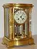 French, Samuel Marti, 8-day time and gong strike brass and glass bow front with fancy glass crystal columns, and bow front, crystal regulator, C. 1900