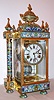 Chinese, (modern) 8-day time/strike brass and enamel crystal regulator, larger model with free standing columns at each side and urn top. Side panels depicting Asian dancers in costume, a sailing ship on the pendulum, C. 1990