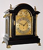 English bracket clock with 8 day, three fusee, 8-Bell quarter chime movement in an ebonized case with gilt columns and flame finials in the style of a century earlier, c1890