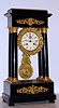 French, 8-day time/strike, Empire style portico 4-column in an ebonized case with gilt bronze mounts, gilt dial and pendulum mantel clock, C. 1860