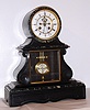 French, Marti and Cie, 8-day time/strike black with contrasting green and white marble mantel clock, with open escapement and visible Ellicott style compensating pendulum, C. 1900