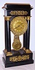 French, 8-day time/strike 4-column Empire style mantel clock in an ebonized case with gilt bronze mounts and pendulum, C. 1860