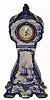 English, in the Dutch blue delft style, porcelain case fitted with a French 8-day balance wheel movement (cylinder escapement). Case is stamped on the back with an English logo.