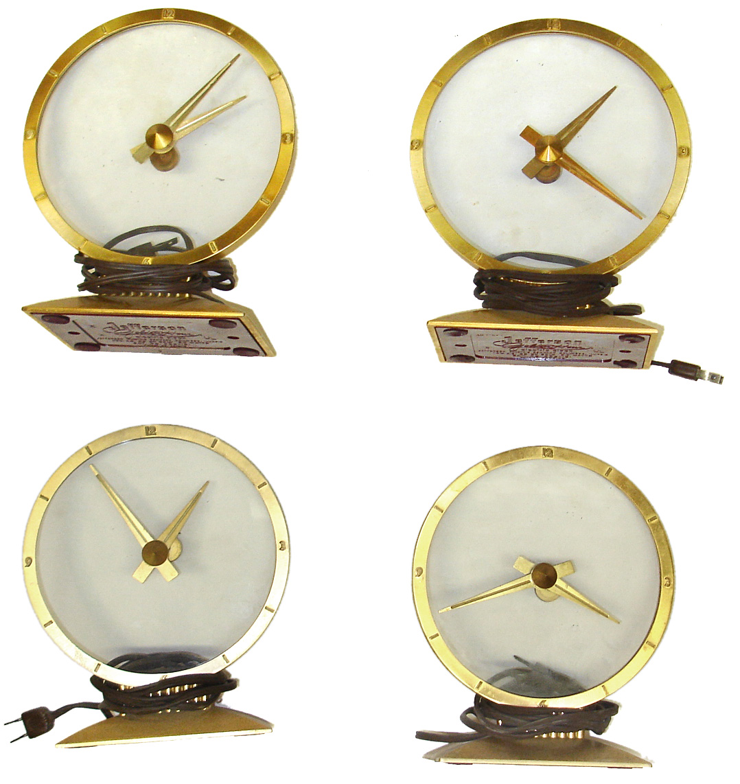 Four Golden Hour electric mystery clocks. All complete with undamaged glass and red plastic bottom covers. — Antique Clocks Price Guide