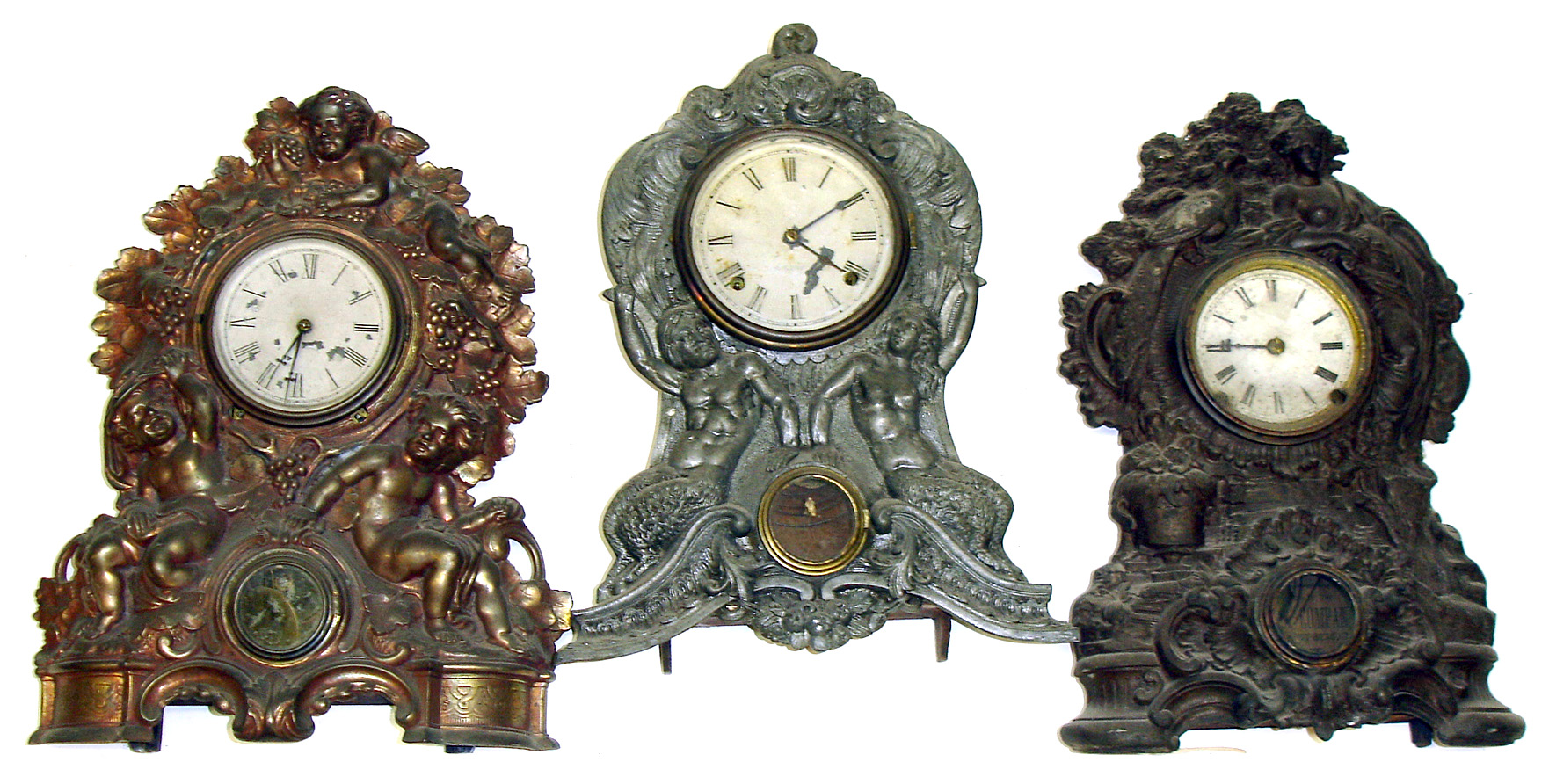 Three large Connecticut 8-day iron fronts 2 with American Clock Co. inside labels. Each with bold human figurals. Largest 19" tall. — Antique Clocks Price Guide