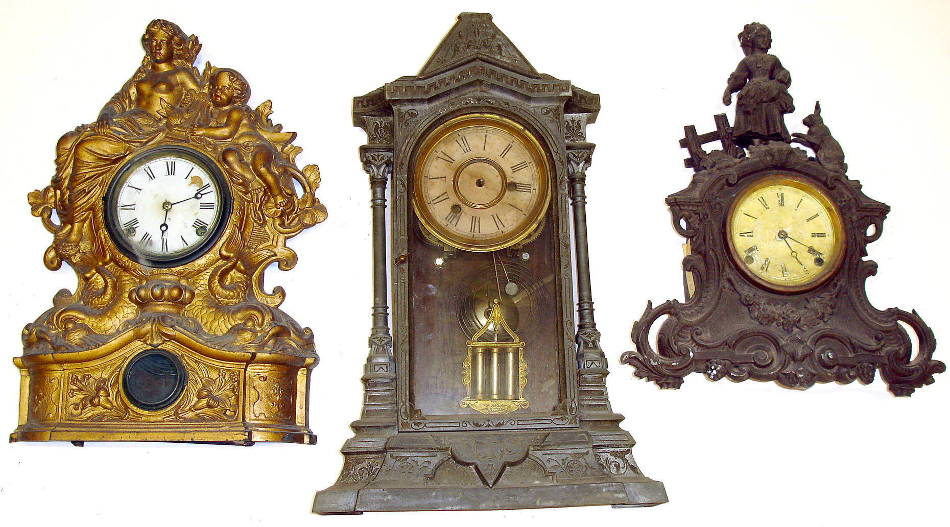 Three large 8-day cast metal mantel clocks. Detailed elaborate castings. Two column has 3 barrel pendulum. Smallest has cute begging hare. Largest is 22" high. — Antique Clocks Price Guide