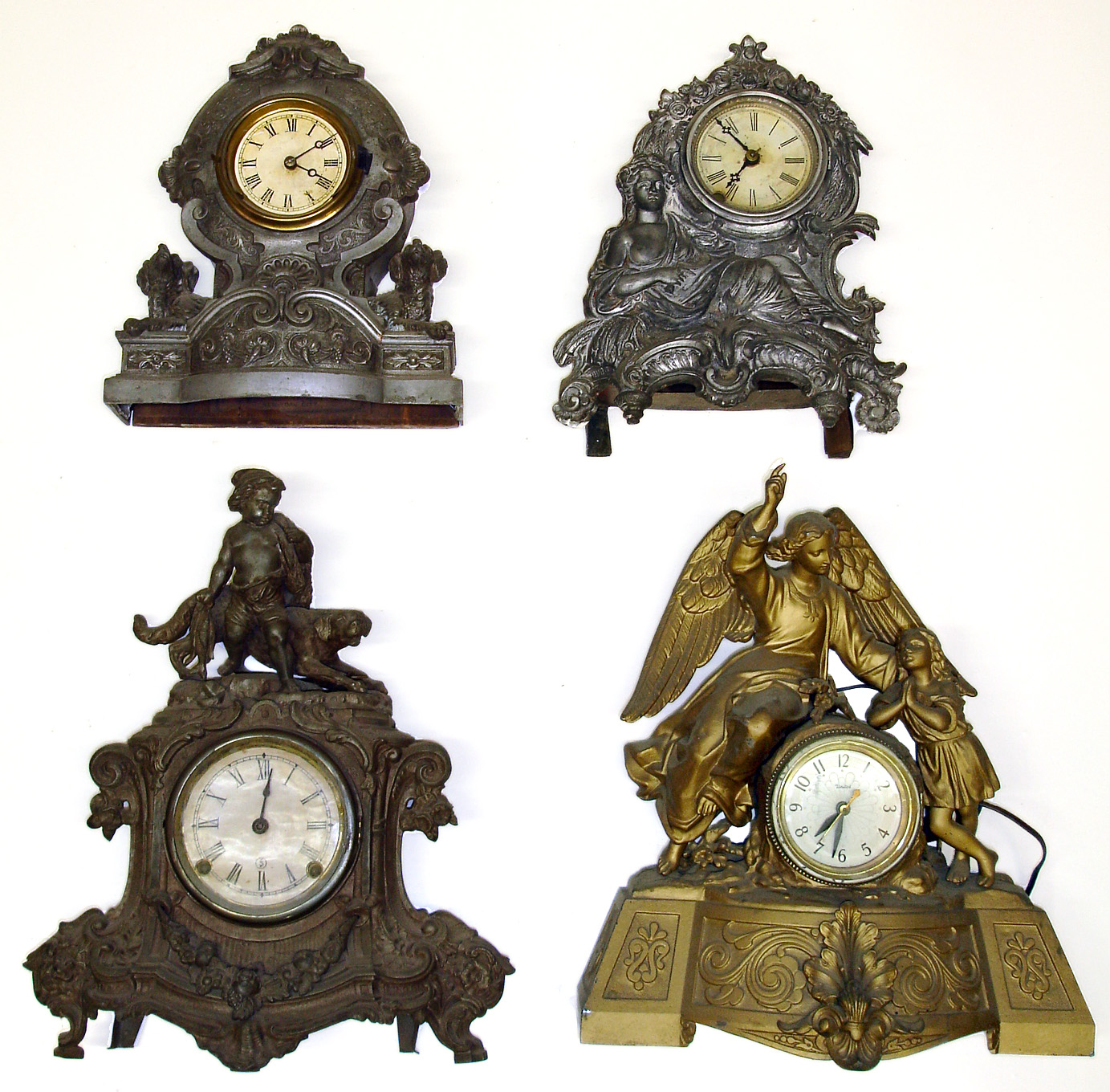 Four cast metal figural mantel clocks. Highly detailed castings, 2 with dogs (1 a Waterbury). Largest, with winged angel and United electric works, is 16" tall. — Antique Clocks Price Guide