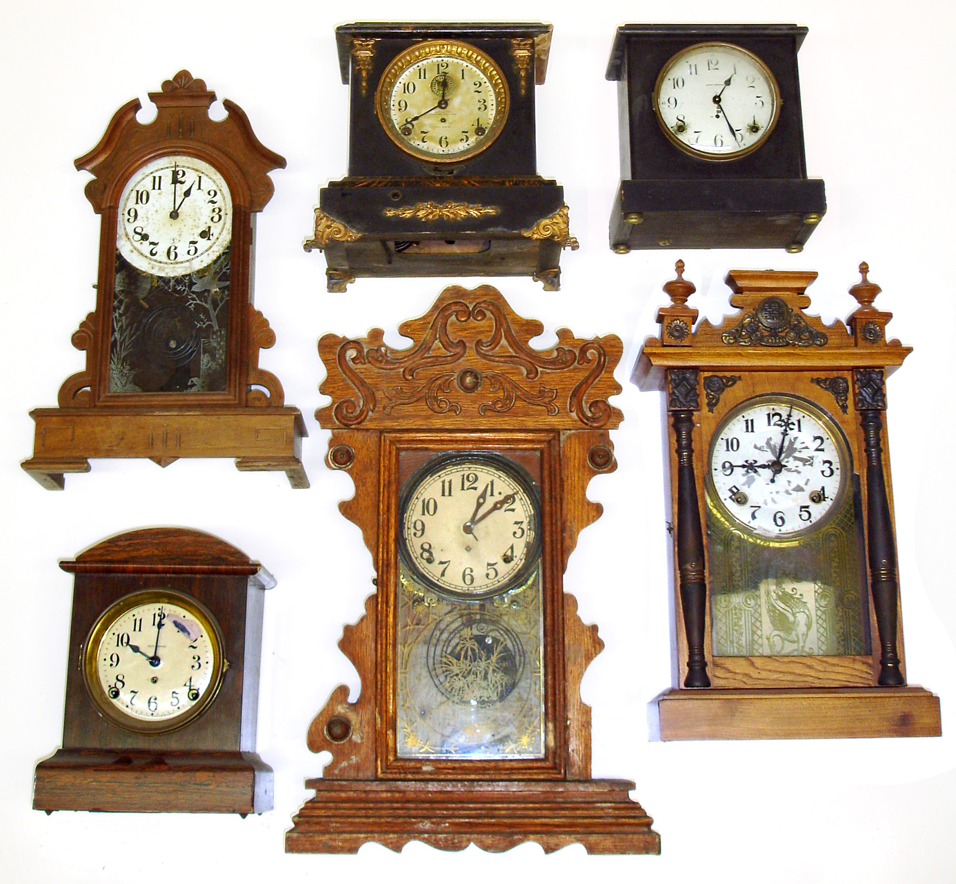 Six wood case 8-day mantel clocks. 1 Asian with full label of Japanese letters on back, 3 Seth Thomas (1 long-alarm), 1 Ansonia, etc. Tallest is 23" high. — Antique Clocks Price Guide