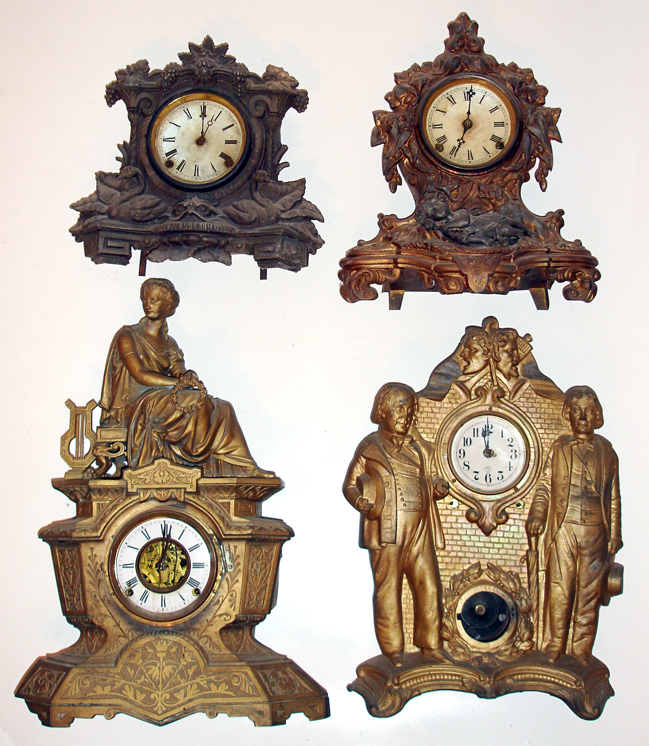Four cast metal 8-day clocks. Detailed and decorative. Largest is 21" high. — Antique Clocks Price Guide