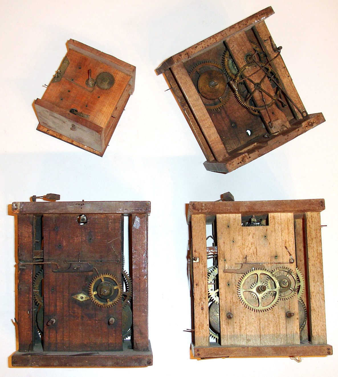 Four Black Forest wooden plate weight driven movements including three of standard size at 8" high and one unusual miniature size. — Antique Clocks Price Guide