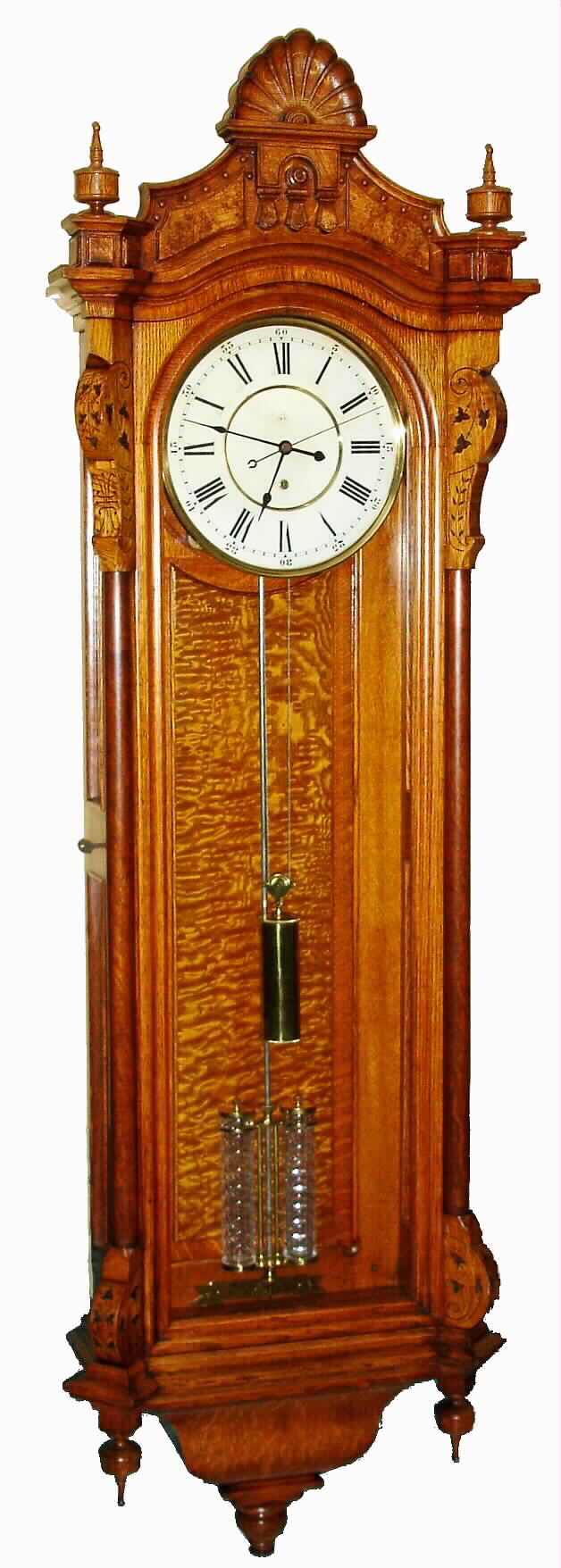 Seth Thomas Clock Co., Thomaston, Conn., "Regulator No. 19" wall clock 8 day time only weight driven movement with Mercury two-jar pendulum in oak case with burled highlights on top crest and raised burled panel on backboard with painted metal dial, c1886 — Antique Clocks Price Guide