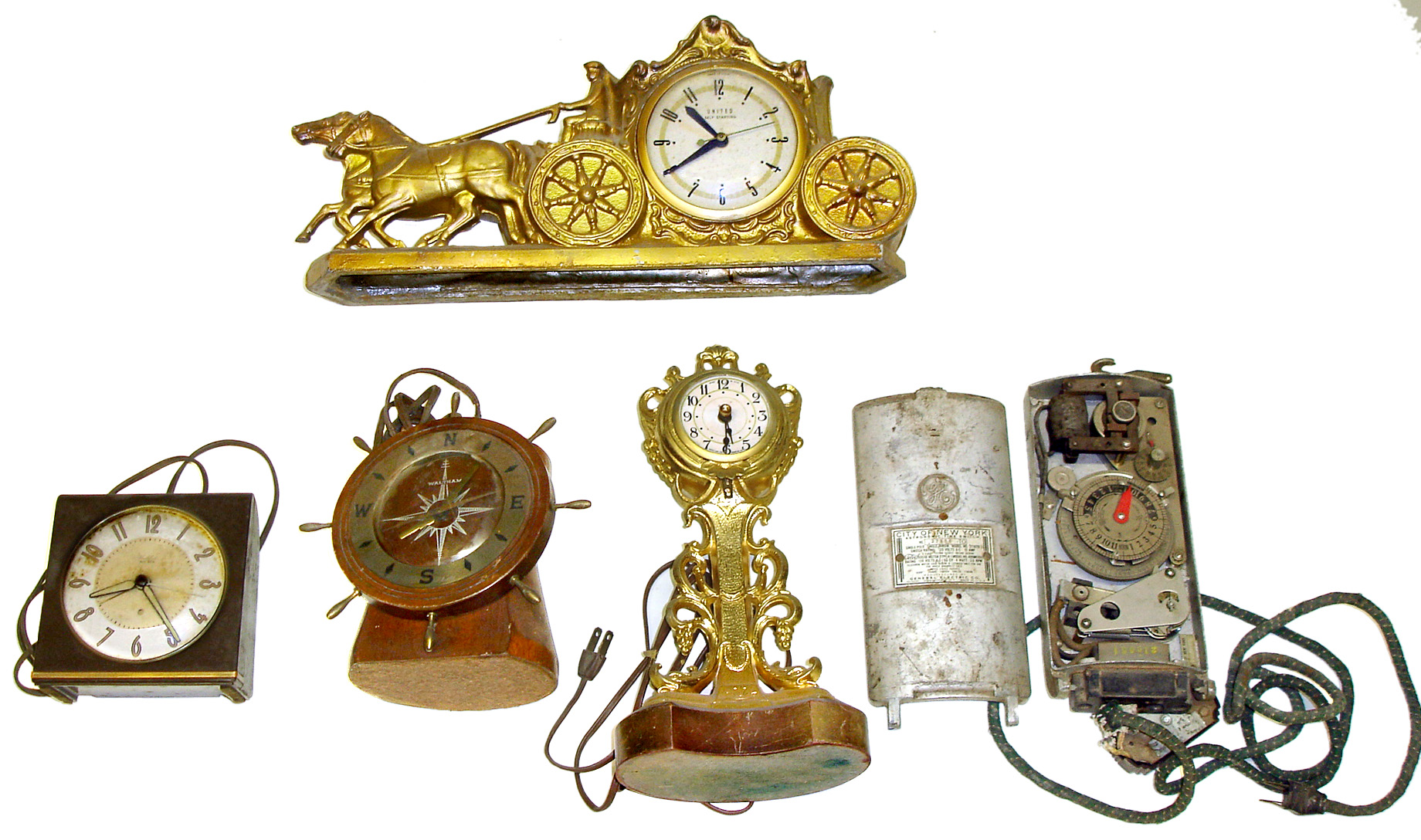 Five electric clocks. Includes Waltham yacht wheel, Big Ben in Bakelite case, United coach and post, and GE City of New York Astronomic Time Switch. Tallest is 12" high. — Antique Clocks Price Guide