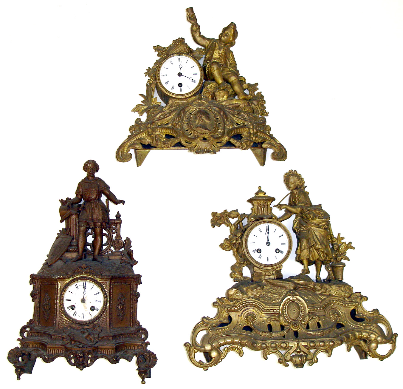 Three French cast-metal figural mantel clocks. All three with elaborate detailed cases, white porcelain dials and round French movements -- two are count wheel striking on bell, other is time only. Shortest shows lad raising his cup, tallest (18") is a standing knight. — Antique Clocks Price Guide
