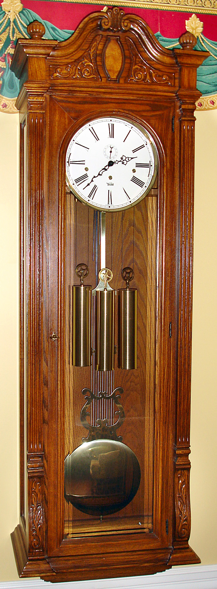 Trend Clock Co., Zeeland, Michigan "Jeweler's Regulator" wall clock with 8 day triple chime weight driven movement with selector for Westminster, St. Michael or Whitington. The case is oak and the dial is enamel, c1980. — Antique Clocks Price Guide