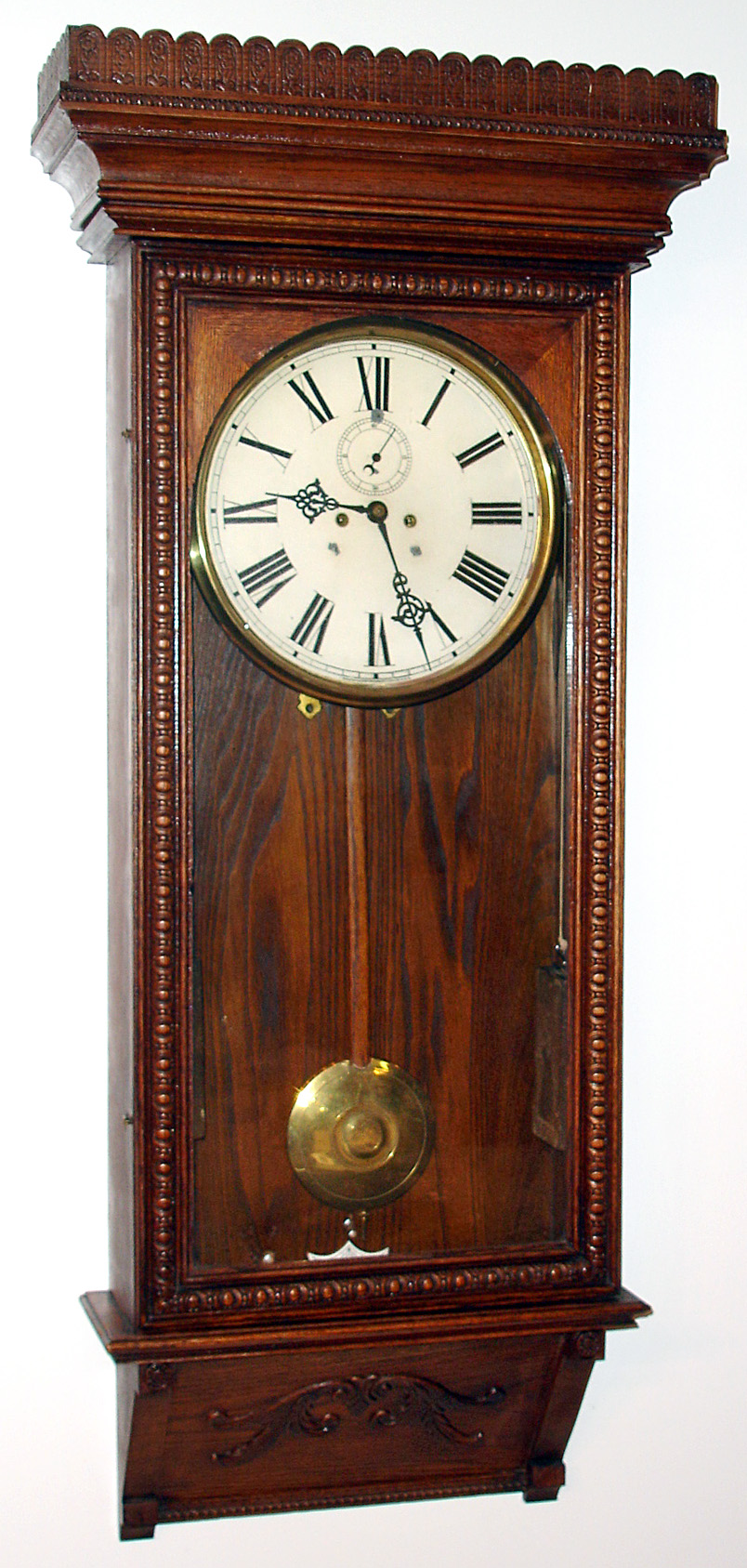 Waterbury Clock Co., Waterbury, Conn., "Regulator No. 67" wall clock 8 day time only 2-weight driven movement in oak case with painted metal dial with Waterbury G-clef hands, c1906 — Antique Clocks Price Guide