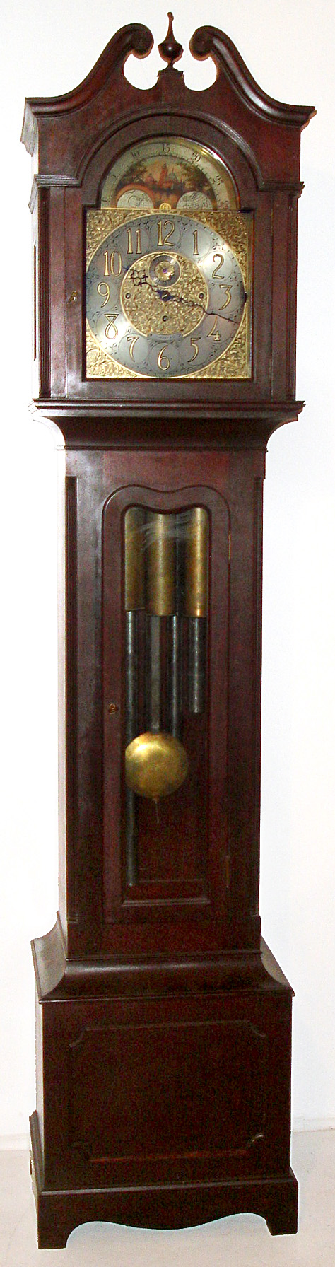 American, for Tiffany and Co., New York 8 day, quarter chiming, 3-weight, playing Westminster tune on 5 tubes in a mahogany case with reeded corner columns on both the broken arch hood with center final and the trunk. Has Durfee chime tubes. The silvered and brass dial has moon phase, serpentine hands, silent / chime selector, raised brass numerals and intricately cut and applied floral spandrels and center, c1900 — Antique Clocks Price Guide